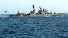 Russian Navy's Antisubmarine Warfare Ship 'Admiral Tributs' conveys messages via flag signals with Chinese Navy's Zhoushan missile frigate (not pictured) on the Gulf of Aden, on September 2, 2009.