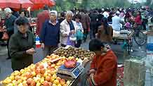 Residents go around at a market on Meiqi Lane in Urumqi, capital city of northwest China's Xinjiang Uygur Autonomous Region, September 4, 2009.