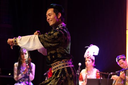 Members of China's Xinjiang Twelve Mukams Art Performing Troupe perform in Algiers, capital of Algeria, September 4, 2009.