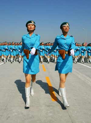 Photo taken on July 9, 2009 shows Zhang Xiaofei (L) and Zhao Na, both are 2009 graduating students of universities in Beijing, take part in the parade training as captains of female militia square in Beijing, capital of China. 