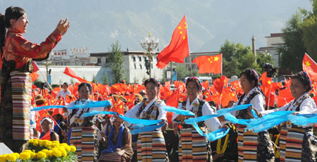 Residents perform a patriotic song at the Potala Palace square in Lhasa, capital of southwest China's Tibet Autonomous Region, September 5, 2009. 