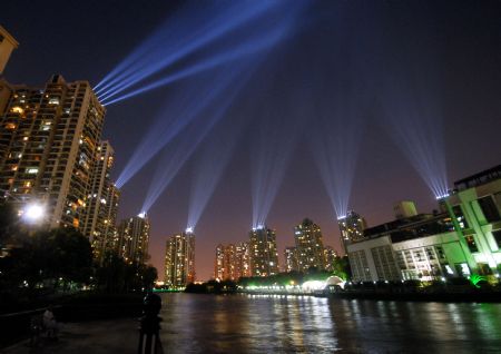 Photo taken on September 6, 2009 shows the dazzling searchlight intersection as the National Day Celebration nocturnal illuminations are in the process of readjustment, along the bank of the Suzhou River, in downtown Shanghai, east China.