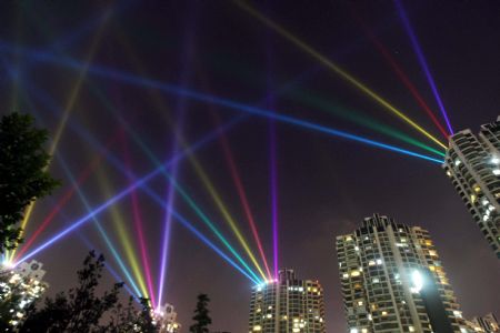 Photo taken on September 6, 2009 shows the dazzling searchlight intersection as the National Day Celebration nocturnal illuminations are in the process of readjustment, along the bank of the Suzhou River, in downtown Shanghai, east China.