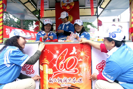 Volunteers decorate the service station for the National Day celebrations on a street in Beijing, China, September 7, 2009.