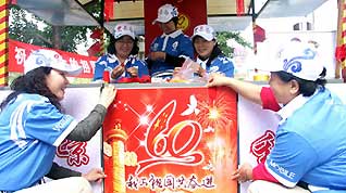 Volunteers decorate the service station for the National Day celebrations on a street in Beijing, China, September 7, 2009.