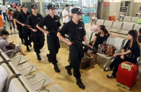 A group of policemen patrol at the waiting hall in Hangzhou Railway Station, in east China's Zhejiang Province, September 8, 2009.