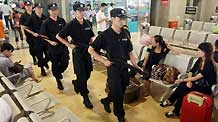 A group of policemen patrol at the waiting hall in Hangzhou Railway Station, in east China's Zhejiang Province, September 8, 2009.