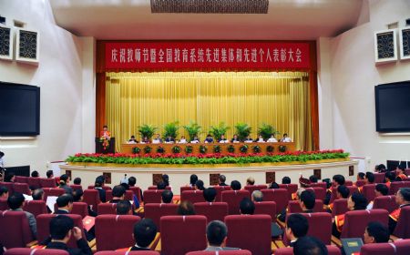 Representatives attend a meeting to honor outstanding teachers in Beijing, capital of China, September 9, 2009, on the eve of China's 25th Teachers' Day. 