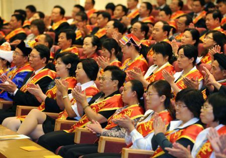 Representatives attend a meeting to honor outstanding teachers in Beijing, capital of China, September 9, 2009, on the eve of China's 25th Teachers' Day. 