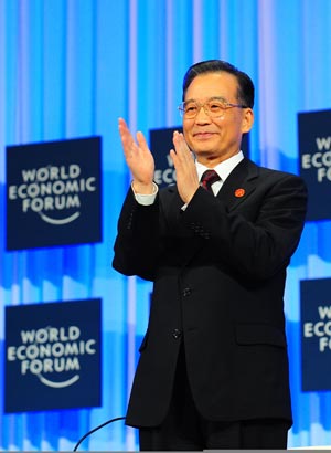 Chinese Premier Wen Jiabao applauses before addressing the opening plenary of the Annual Meeting of the New Champions 2009, or the Summer Davos, in Dalian, northeast China's Liaoning Province, September 10, 2009.