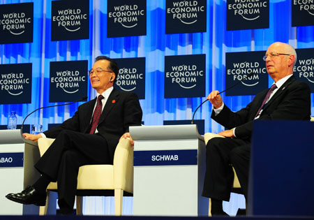 Chinese Premier Wen Jiabao (L) and Executive Chairman of World Economic Forum Klaus Schwab attends the opening plenary of the Annual Meeting of the New Champions 2009, or the Summer Davos, in Dalian, northeast China's Liaoning Province, September 10, 2009. 