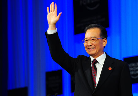 Chinese Premier Wen Jiabao waves before addressing the opening plenary of the Annual Meeting of the New Champions 2009, or the Summer Davos, in Dalian, northeast China's Liaoning Province, September 10, 2009.