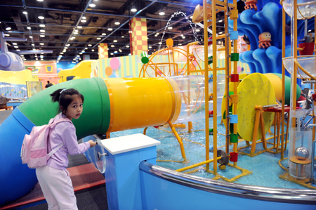 A girl operates an instrument at the new hall of China Science and Technology Museum in Beijing, China, September 13, 2009. The new hall of China Science and Technology Museum which located in the Olympic Park will open to the public on September 20.