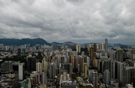 The Kowloon Peninsula is seen under dark clouds in Hong Kong, south China, September 14, 2009.