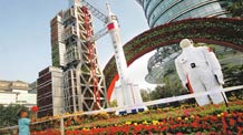 A child plays nearby the aerospace science and technology flower parterre in Beijing yesterday.