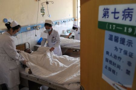 A wounded miner of the Xinhua No. 4 coal mine is treated at a hospital in Pingdingshan City, central China's Henan Province, on September 9, 2009. A total of 93 people were working in the coal mine where a gas explosion happened Tuesday morning, leaving at least 42 dead. 