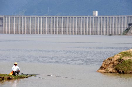 A local goes fishing near the Three Gorges reservoir in Yichang, a city of central China's Hubei Province, September 15, 2009.