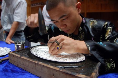 A competitor makes embroidery during a traditional handicraft competition in Kaili, southwest China's Guizhou Province, Septemebr 15, 2009.
