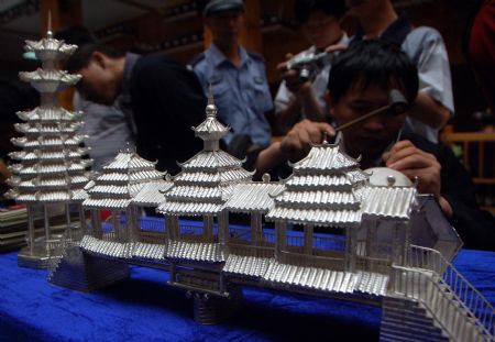 A competitor makes a silver sculpture during a traditional handicraft competition in Kaili, southwest China's Guizhou Province, September 15, 2009. 