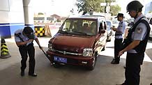 Policemen check a car at a checkpoint in Beijing, capital of China, September 15, 2009, in a move to secure the celebrations for the 60th anniversary of the founding of the People's Republic of China, whose National Day falls on October 1.