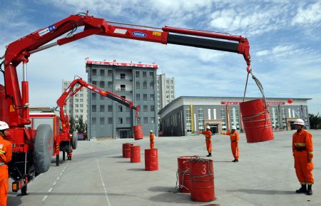 Fire fighters attend a drill in Zhongwei of northwest China's Ningxia Hui Autonomous Region September 15, 2009. The drill was for safeguarding the security of celebrations of the 60th anniversary of the founding of the People's Republic of China, which falls on October 1.