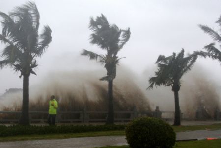 Surging billows splash onto the coastal road as an aftermath of the gales and heavy rains brought by the tropical storm Koppu, at Zhuhai City, south China's Guangdong Province, September 15, 2009.