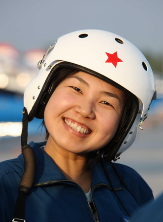 A female pilot smiles at the camera during a rest from training at an airport in Beijing, China, in this photo taken on July 14.