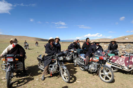 Local herdsmen ride motorbikes to attend a house-warming party held by Cering Tonzhub for his new house in Bangoin County, southwest China&apos;s Tibet Autonomous Region, September 15, 2009.