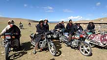 Local herdsmen ride motorbikes to attend a house-warming party held by Cering Tonzhub for his new house in Bangoin County, southwest China's Tibet Autonomous Region, September 15, 2009.