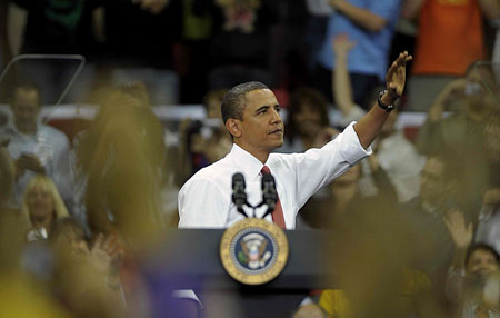 US President Barack Obama waves to the crowd during a rally on health insurance reform at the Comcast Center at the University of Maryland in College Park, Maryland, September 17, 2009.