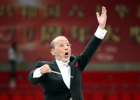 Conductor Cao Peng directs the rehearsal of Yellow River Cantata in Shanghai, east China, September 18, 2009. The cantata, with participation of more than 22,000 people, will be staged with live broadcasting in 10 provinces and regions on Saturday to commemorate the 70th anniversary of the cantata composed by Xian Xinghai, a famous Chinese composer, and the 60th birthday of the People's Republic of China.