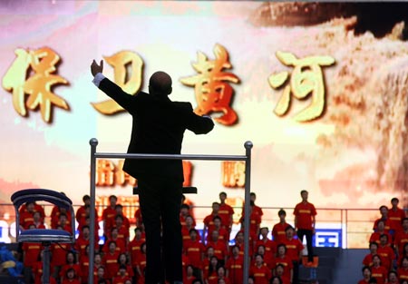 Conductor Cao Peng directs the rehearsal of Yellow River Cantata in Shanghai, east China, September 18, 2009. The cantata, with participation of more than 22,000 people, will be staged with live broadcasting in 10 provinces and regions on Saturday to commemorate the 70th anniversary of the cantata composed by Xian Xinghai, a famous Chinese composer, and the 60th birthday of the People's Republic of China.