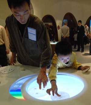 A boy plays a game in the new China Science and Technology Museum in Beijing, capital of China, September 20, 2009. The Hi-tech and newly-built museum covering an area of 48,000 square meters was opened to the public on Sunday. 