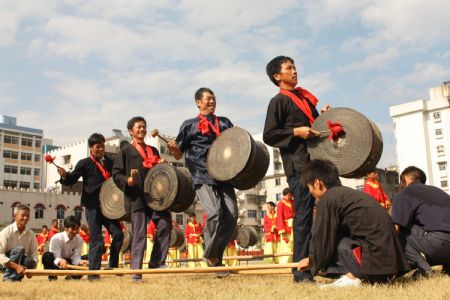 Performers revel in the bamboo dance to mark the forthcoming grand celebration of the 60th anniversary of the founding of the People's Republic of China, at Hechi City, southwest China's Guangxi Zhuang Autonomous Region, September 19, 2009.