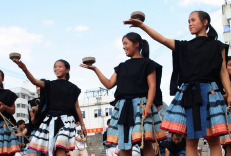 A group of young women take part in the teetotum gyration match to mark the forthcoming grand celebration of the 60th anniversary of the founding of the People's Republic of China, at Hechi City, southwest China's Guangxi Zhuang Autonomous Region, September 19, 2009.