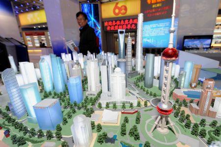 A man visits a model of the Shanghai Pudong New District presented at an exhibition showcasing the achievements New China has made in the past six decades in Beijing, China, September 20, 2009. 