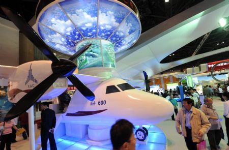 Audience visit a model of Xinzhou 600 aircraft developed by China Aviation Industry Corporation I (AVIC I) at an exhibition showcasing the achievements New China has made in the past six decades in Beijing, China, September 20, 2009.