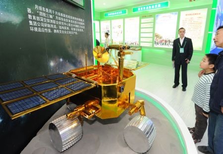 Audience appreciate a model of moonbuggy at an exhibition showcasing the achievements New China has made in the past six decades in Beijing, China, September 20, 2009. 