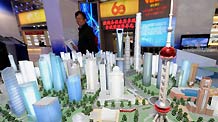 A man visits a model of the Shanghai Pudong New District presented at an exhibition showcasing the achievements New China has made in the past six decades in Beijing, China, September 20, 2009.