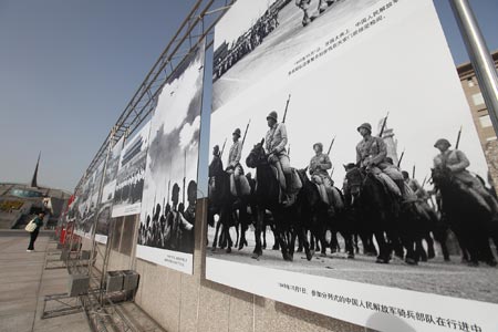 A woman visits a photo exhibition showcasing the classical moments during the 60 years after the founding of the People's Republic of China, in Beijing, China, on September 20, 2009.