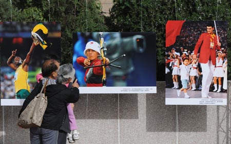 People visit a photo exhibition showcasing the classical moments during the 60 years after the founding of the People's Republic of China, in Beijing, China, on September 20, 2009. 