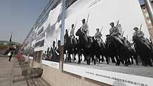 A woman visits a photo exhibition showcasing the classical moments during the 60 years after the founding of the People's Republic of China, in Beijing, China, on September 20, 2009.