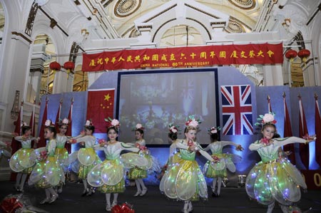 Children dance during a reception to celebrate the upcoming 60th anniversary of the founding of the People's Republic of China, in London, Britain, September 20, 2009.