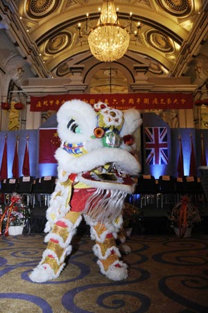 Performers play the lion dance during a reception to celebrate the upcoming 60th anniversary of the founding of the People's Republic of China, in London, Britain, September 20, 2009.