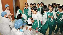 Students from the High School affiliated to Minzu University of China prepare to receive the A/H1N1 flu vaccinations in Beijing, capital of China, on September 21, 2009.