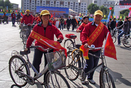 Elders ride bicycles as they participate in a campaign to promote the idea of the Car-Free Day in Hohhot, capital of north China's Inner Mongolia Autonomous Region, on September 22, 2009. This Tuesday is China's third Car-Free Day and people are encouraged to walk, ride bikes or take buses instead of driving their cars.