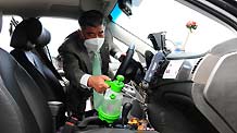 One of the staff members of a gas station disinfects a taxi in Ulsan, South Korea, September 22, 2009.