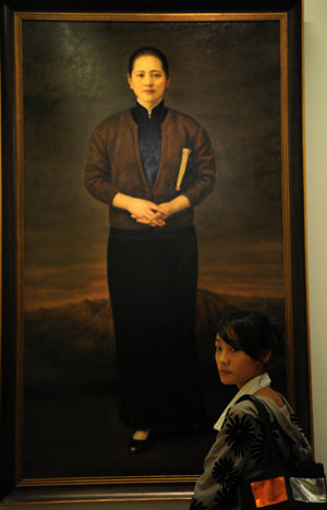 A visitor walks past a portrait of Soong Ching Ling, wife of China's revolutionary forefather Sun Yat-Sen, during an exhibition of artworks reflecting China's major historical subjects since 1840, at the National Art Museum in Beijing, capital of China, on September 22, 2009.