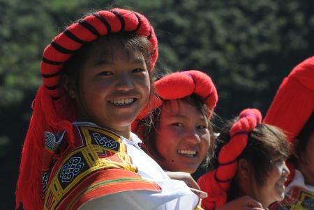 Full-dressed women of the Miao ethnic group attend the opening ceremony of a leek flower cultural festival held in Hezhang, southwest China's Guizhou Province, September 22, 2009. The festival opened on Tuesday in Hezhang county that grows wild leek plants of more than 30 square kilometers.