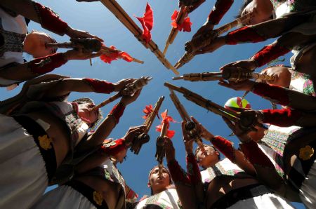 Full-dressed men of the Miao ethnic group dance at the opening ceremony of a leek flower cultural festival held in Hezhang, southwest China's Guizhou Province, September 22, 2009. The festival opened on Tuesday in Hezhang county that grows wild leek plants of more than 30 square kilometers.